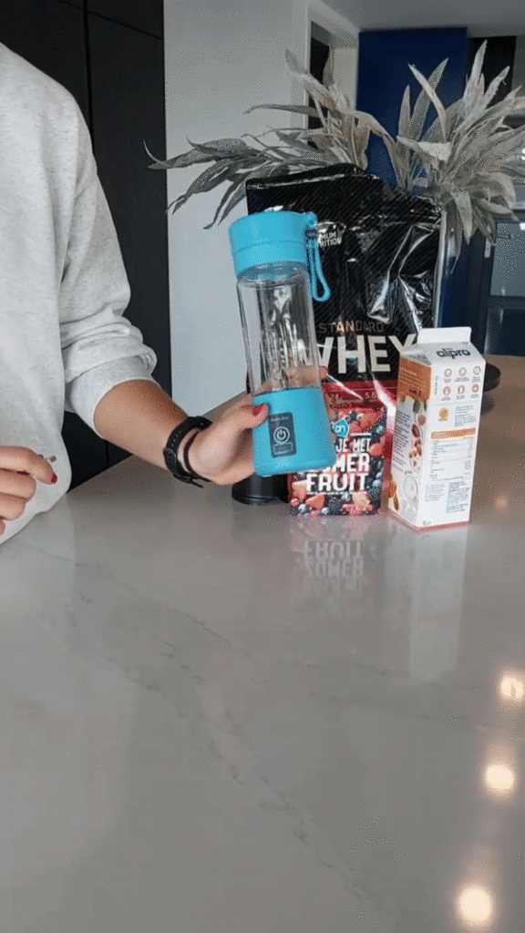 person holds BlendIt Blender in hand