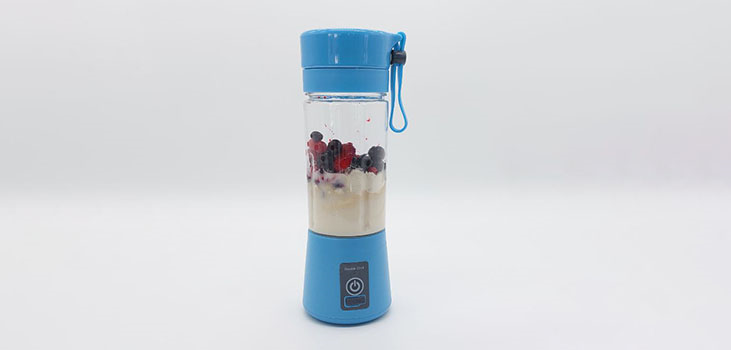 BlendIt Blender in blue smashing fruit